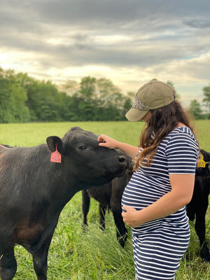Pregnant farmer with cows